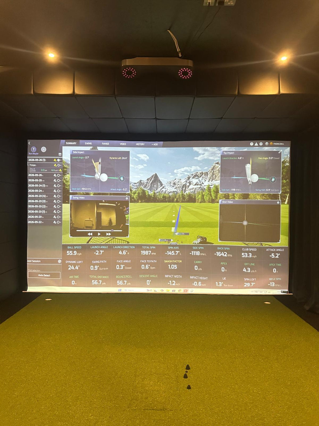 Faux leather ceiling panels above a golf simulator screen with putting cups in the turf
