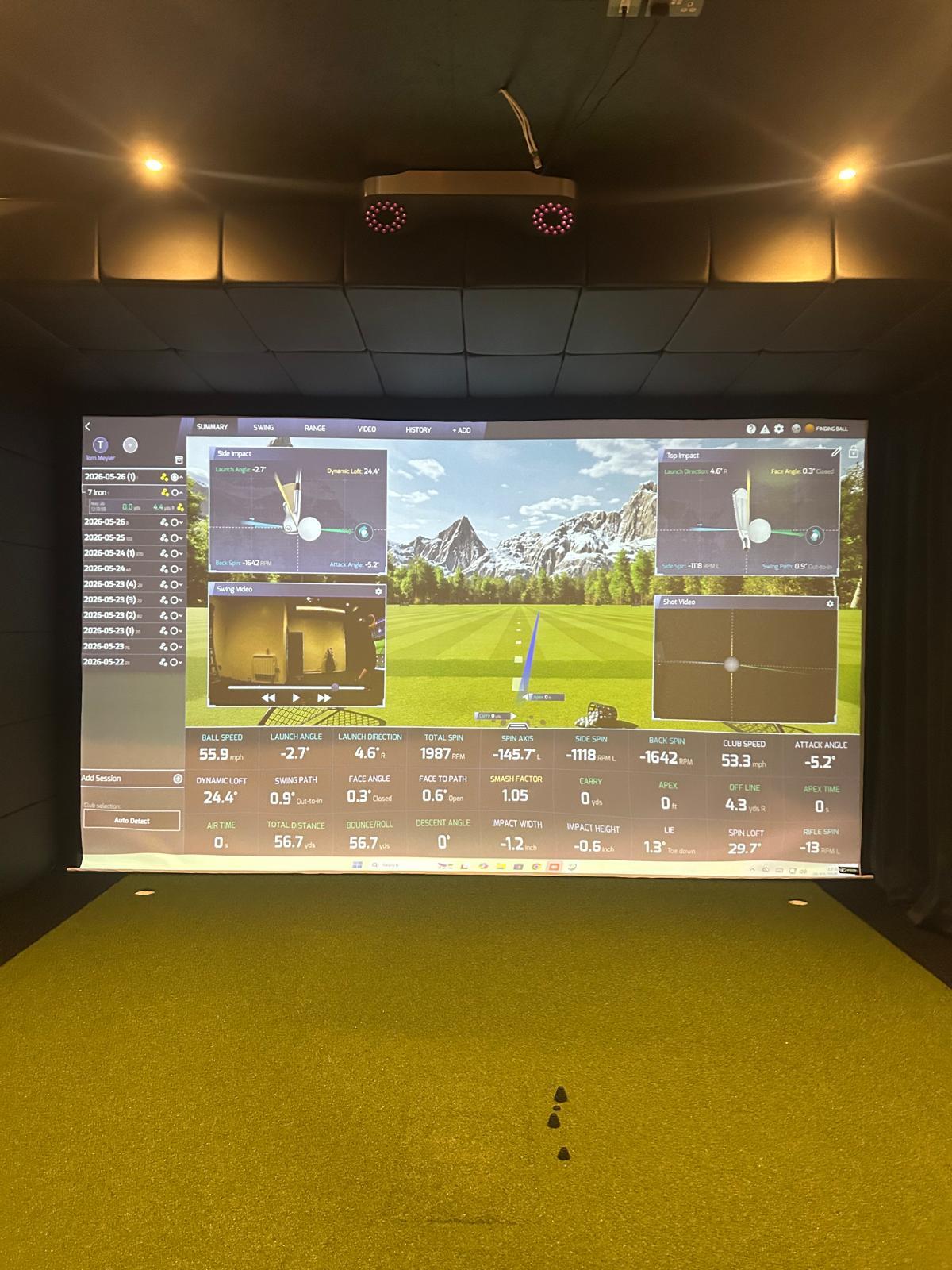 Faux leather ceiling panels above a golf simulator screen with putting cups in the turf