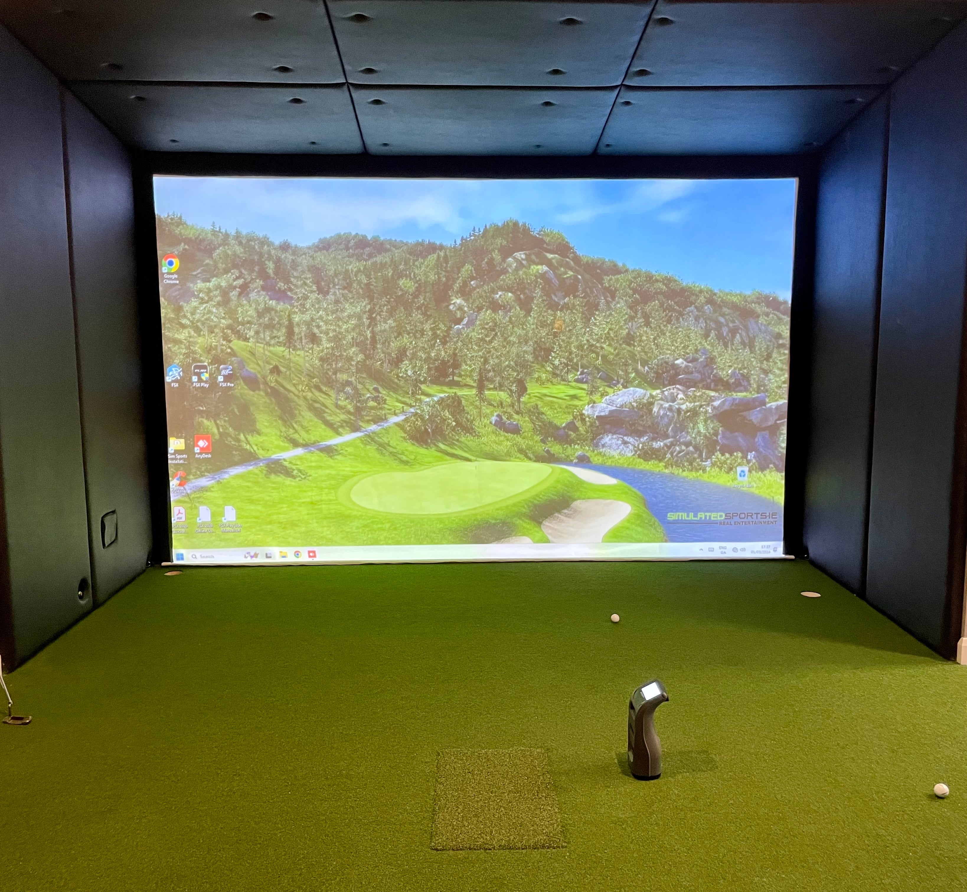 Golf simulator bay fully lined with black faux leather wall and ceiling panels